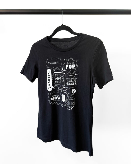 Black t-shirt with white graphic design on a hanger against a white background